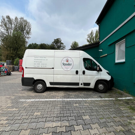 Lieferwagen von Sattel's Getränke, geparkt vor dem Getränkemarkt in Altenessen, mit Adresse und Kontaktdaten auf der Seite.